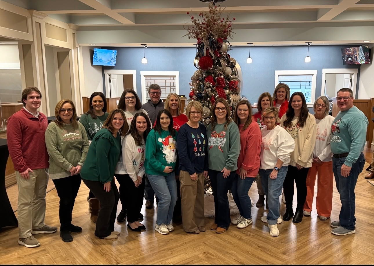 The Greenfield Banking Company Team near the lobby Christmas tree